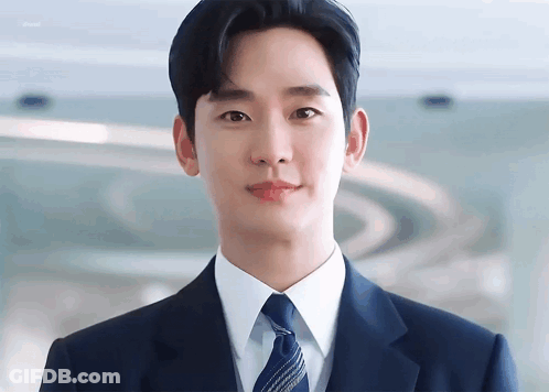 Young Man In Suit And Tie Looking At Camera GIF