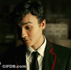 Young Man In Suit And Tie Looking At Something GIF