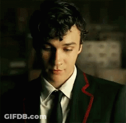 Young Man In Suit And Tie Looking Down GIF