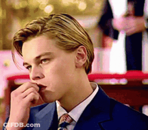 Young Man In Suit And Tie Looking Down GIF