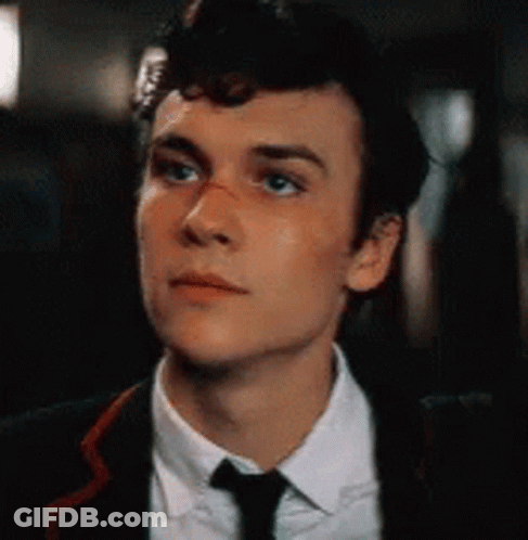 Young Man In Suit And Tie Looking Up GIF