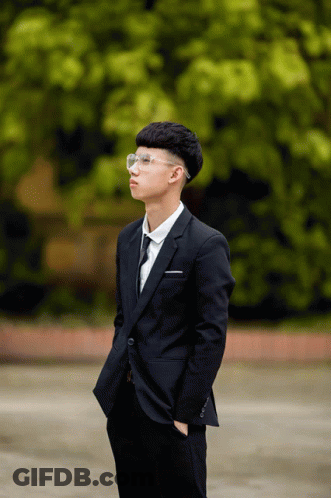 Young Man In Suit And Tie With Hands In Pockets GIF