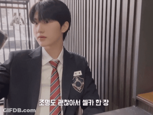 Young Man In Suit And Tie With Korean Writing GIF