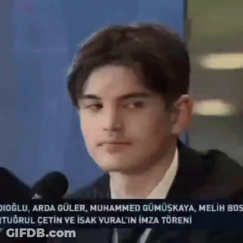 Young Man In Suit At Microphone GIF