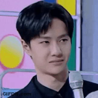 Young Man In Suit Holding Microphone GIF