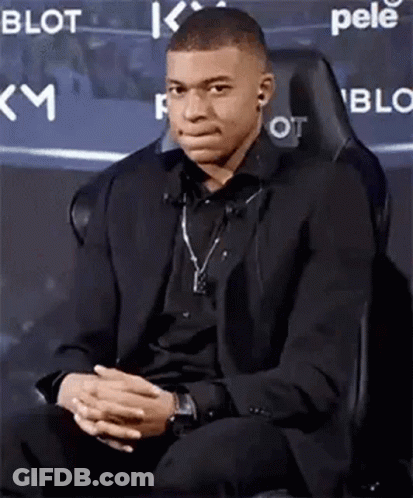Young Man In Suit Sitting With Hands Folded GIF