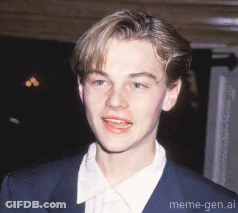 Young Man In Suit Smiling For Camera GIF