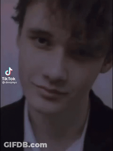 Young Man In Suit Smiling In Elevator GIF