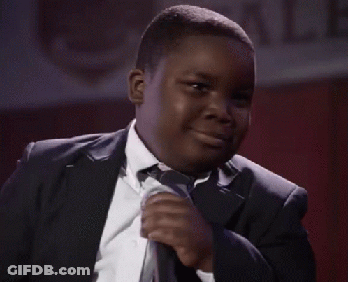 Young Man In Suit Smiling With Microphone GIF