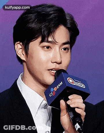 Young Man In Suit Talking Into Microphone GIF