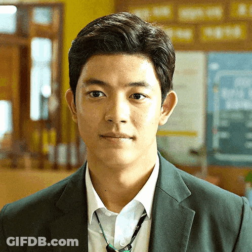 Young Man In Suit Tie Looking At Camera GIF