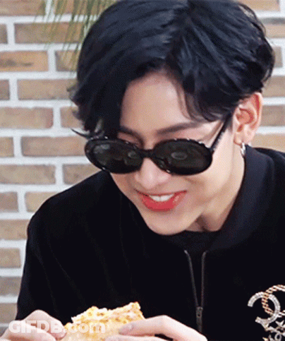 Young Man In Sunglasses And Black Jacket Eating Pizza GIF