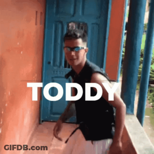 Young Man In Sunglasses By Blue Door With Toddy GIF