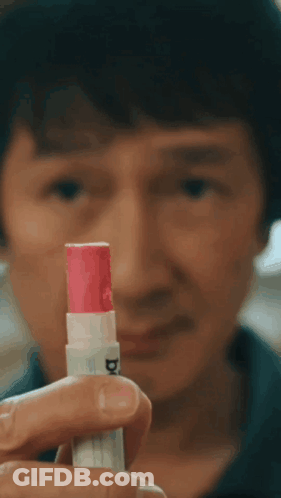 Young Man In Sweater Making Heart With Hands Chapstick Time GIF