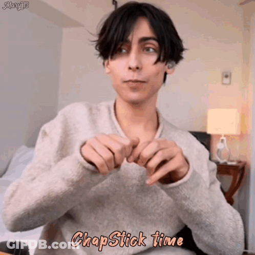 Young Man In Sweater Making Heart With Hands Chapstick Time GIF