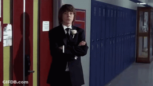 Young Man In Tuxedo Next To Blue Lockers GIF