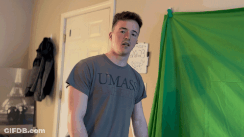 Young Man In UMass Shirt In Front Of Green Screen GIF