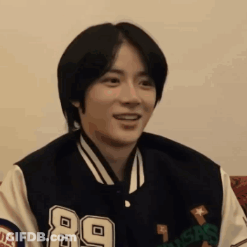 Young Man In Varsity Jacket Smiling GIF
