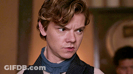 Young Man In Vest And Scarf Making Serious Face GIF