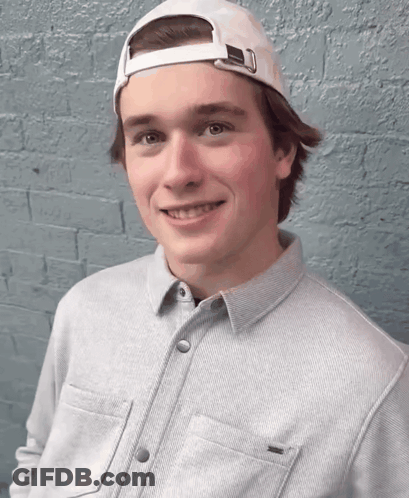 Young Man In White Baseball Cap And Grey Shirt GIF