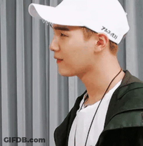 Young Man In White Cap And Green Jacket GIF
