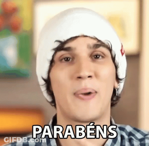 Young Man In White Hat And Plaid Shirt Says Parabéns GIF