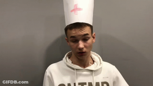 Young Man In White Hoodie And Hat With Pink Cross GIF