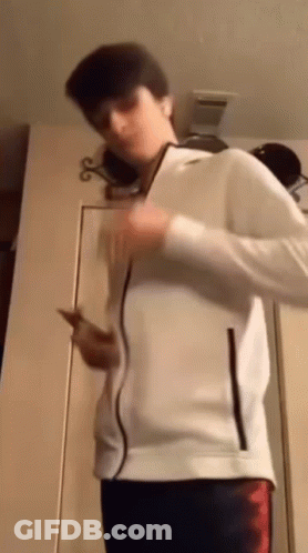 Young Man In White Jacket Holding Cell Phone GIF