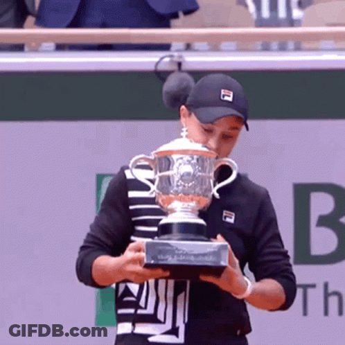 Young Man In White Jacket Holding Road To Kingdom Trophy GIF