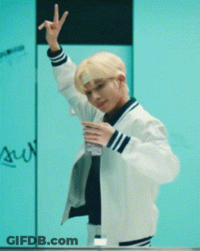 Young Man In White Jacket Making Peace Sign And Holding Water GIF