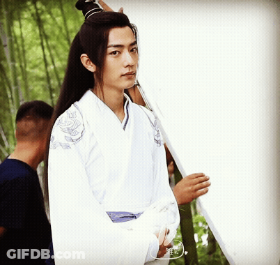 Young Man In White Kimono Holding White Board GIF