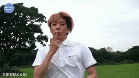 Young Man In White Polo Standing In Field GIF