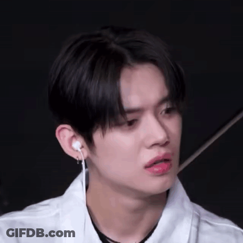 Young Man In White Shirt And Earbuds GIF