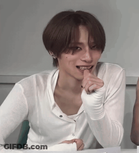 Young Man In White Shirt At Table GIF