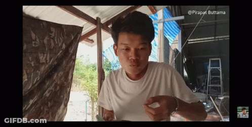 Young Man In White Shirt Eating Meal GIF