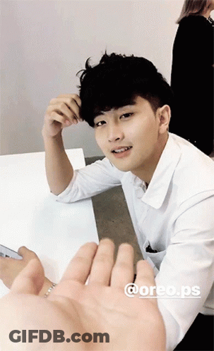 Young Man In White Shirt Hand Reaching Out GIF