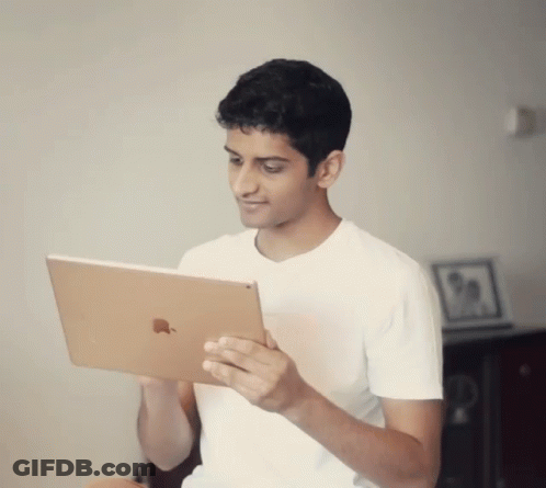 Young Man In White Shirt Holding Apple IPad GIF