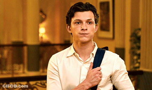 Young Man In White Shirt Holding Blue Bag GIF