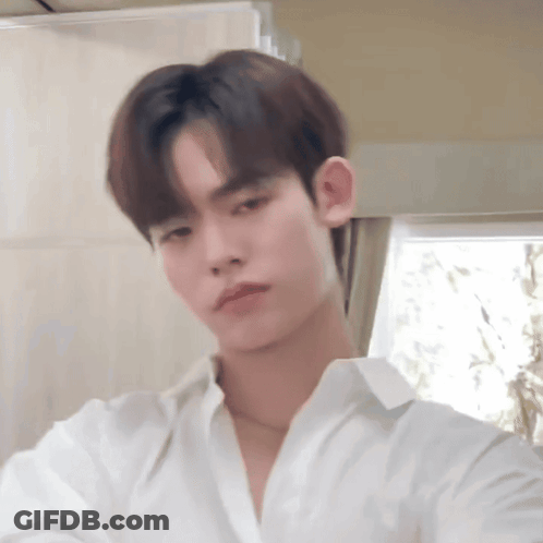 Young Man In White Shirt Looking At Camera GIF