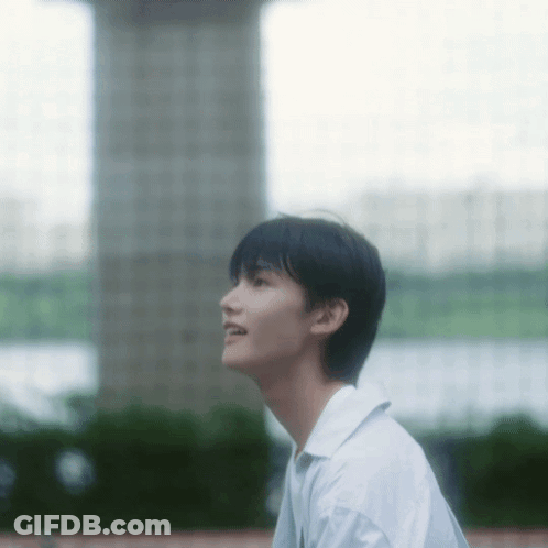 Young Man In White Shirt Looking Up GIF