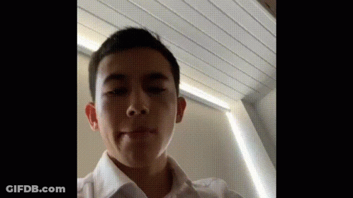 Young Man In White Shirt Making Funny Face GIF