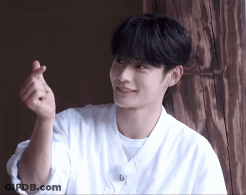 Young Man In White Shirt Making Heart With Hands GIF