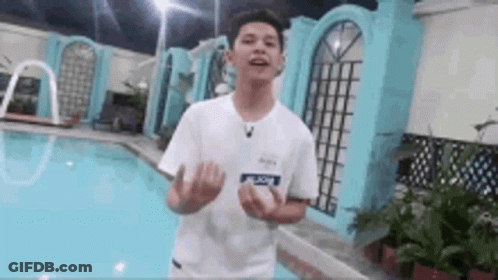 Young Man In White Shirt Next To Pool GIF