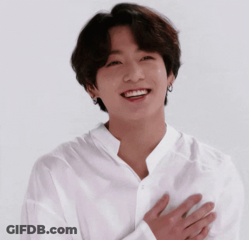 Young Man In White Shirt Smiling Hands To Chest GIF