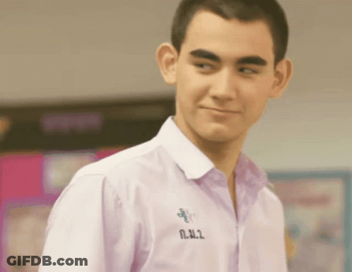 Young Man In White Shirt With N.N.2 On Collar GIF