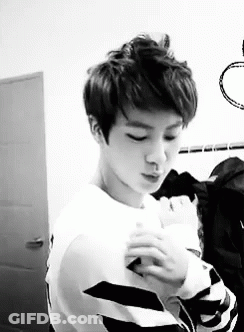 Young Man In White Sweater And Striped Shirt GIF