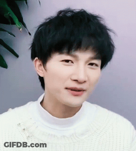 Young Man In White Sweater Close Up GIF