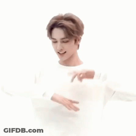 Young Man In White Sweater Dancing With Hands Outstretched GIF