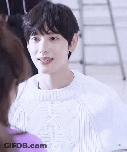 Young Man In White Sweater Smiling At Woman GIF