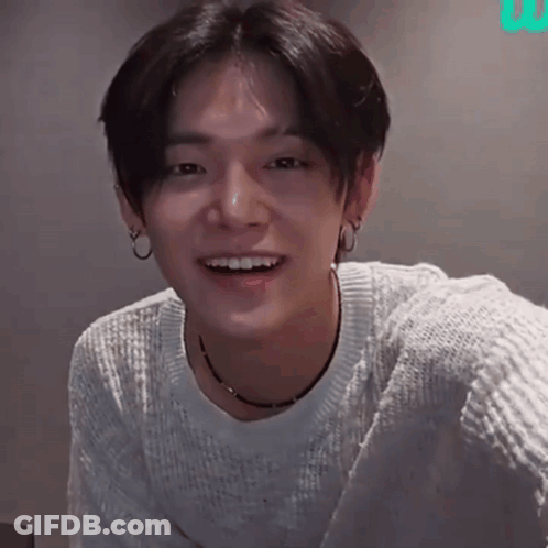 Young Man In White Sweater Smiling With Hoop Earrings GIF